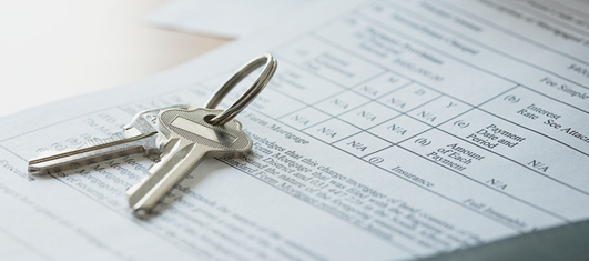 House keys on mortgage document Stock Photo